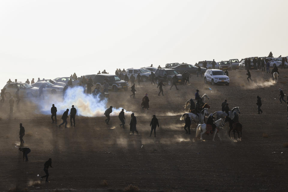 Bedouin protesters clash with Israeli security forces following a protest against an afforestation project by the Jewish National Fund in the Bedouin village of Sa'we al-Atrash in the Negev Desert, southern Israel, Thursday, Jan. 13, 2022. (AP Photo/Tsafrir Abayov)