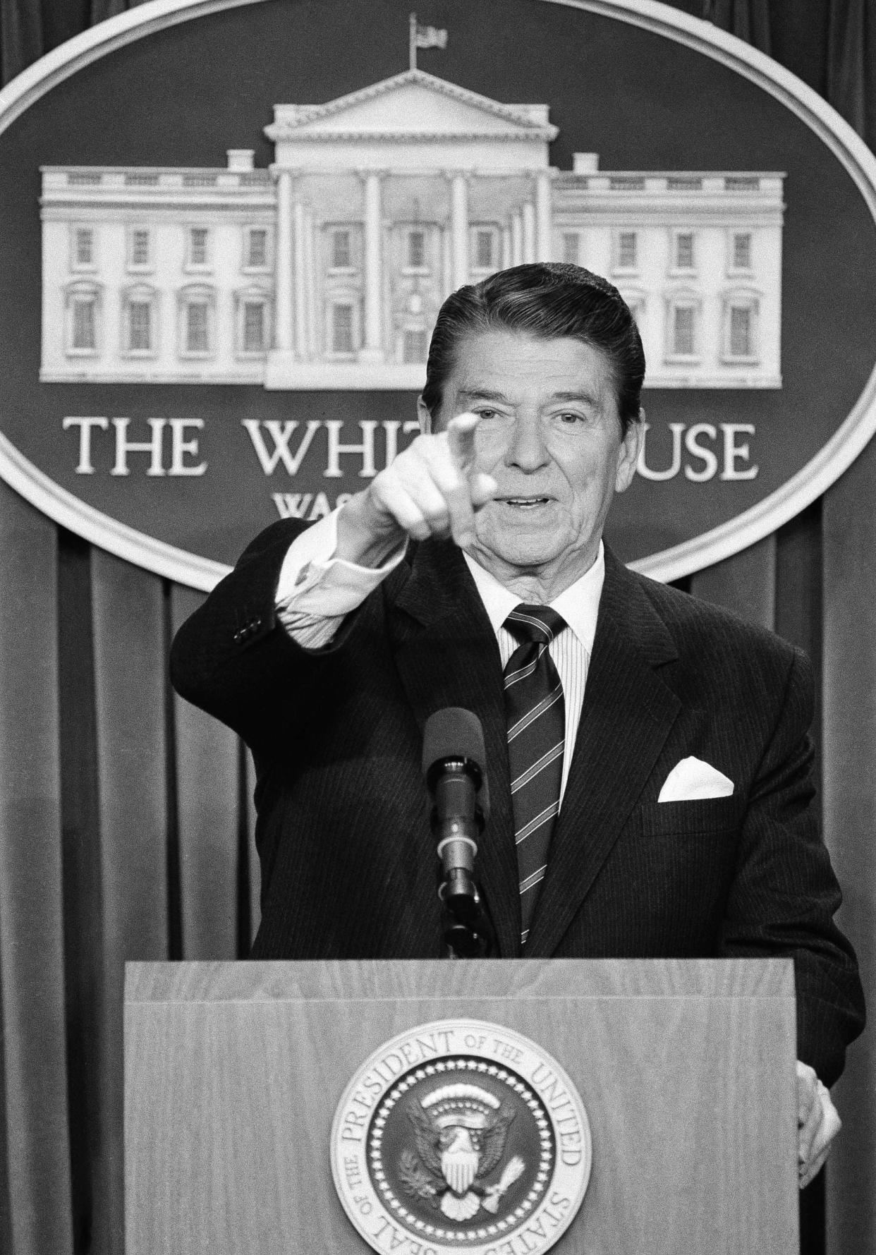 In this Dec. 8, 1984, file photo, President Ronald Reagan points to a reporter during a brief news conference in the White House press briefing room in Washington.