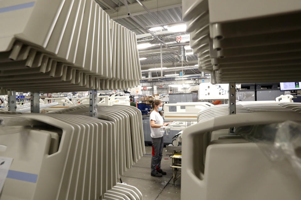 A worker assembles a hospital bed, at the Linet factory in Slany, Czech Republic, Monday, Oct. 19, 2020. A Czech hospital bed maker with a full order book received one more order that was impossible to turn down. The company was approached by Prime Minister Andrej Babis to deliver beds for a military field hospital for 500 COVID-19 patients, to be built this week in Prague. (AP Photo/Petr David Josek)