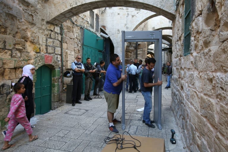 Workers install a metal detector on Al-Wad street in the Muslim quarter of Jerusalem's Old City following a spate of knife attacks, on October 8, 2015