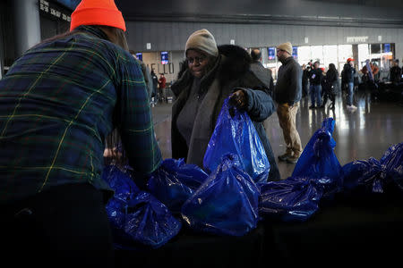 Government employees receive donations at a food distribution center for federal workers impacted by the government shutdown, at the Barclays Center in the Brooklyn borough of New York, U.S., January 22, 2019. REUTERS/Brendan McDermid