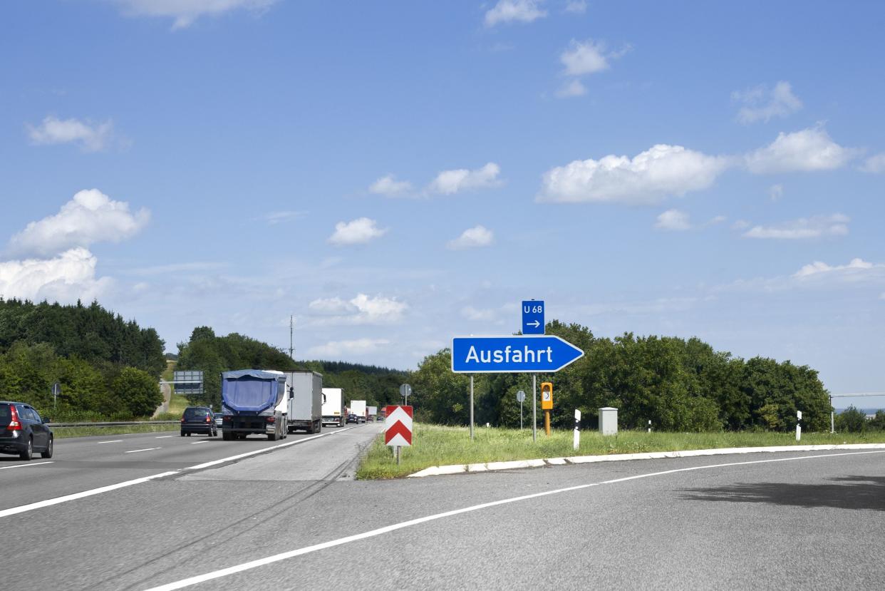 German highway, road sign - Ausfahrt/Exit. Photography has been taken during driving, some motion blur