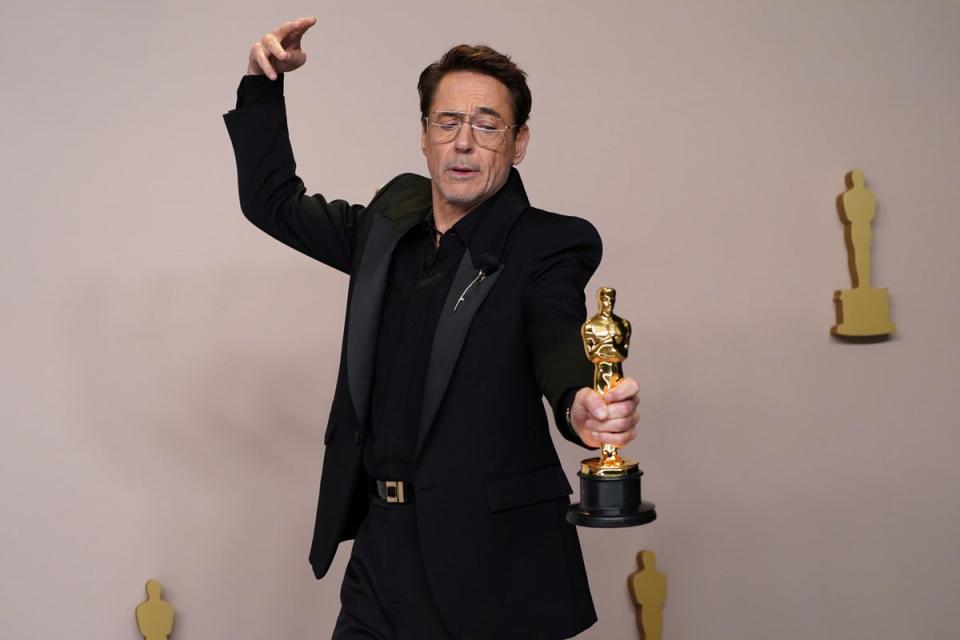 Downey Jr poses with his Oscar (Jordan Strauss/Invision/AP)