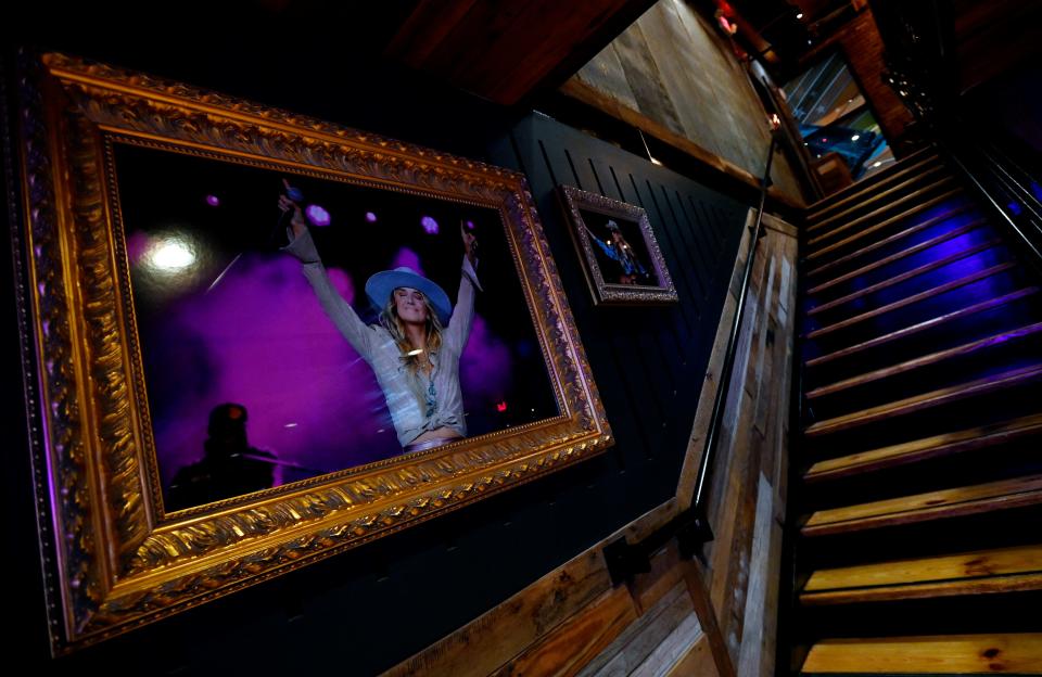 A photograph of Lainey Wilson hangs on the first floor of her new Bell Bottoms Up Bar and restaurant on Thursday, May 30, 2024 in Nashville, Tenn.