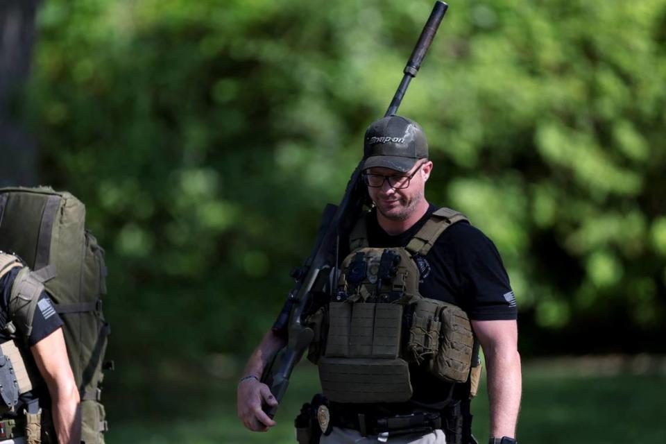 A law officer walks away from the scene at 5000 block of Galway Drive in Charlotte, NC on Monday, April 29, 2024 where multiple law enforcement officers were shot