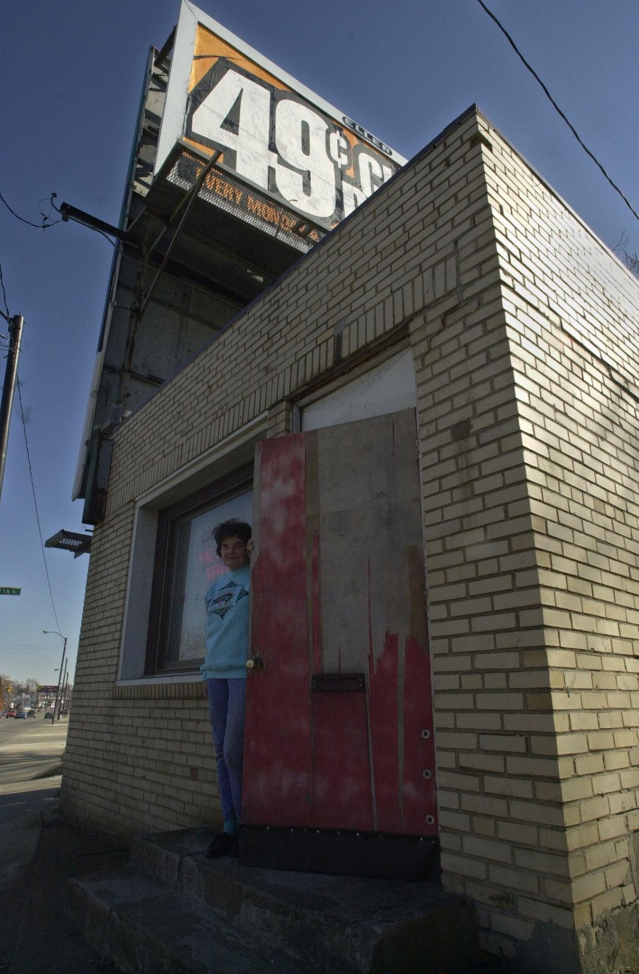 Lea Treen peeks out the door of Cardinal Tax Service at 558 E. Market St. in 2001.