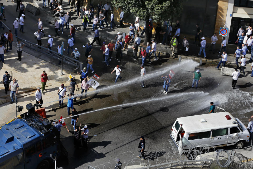 Police use a water cannon against retired army officers demonstrating in Beirut, Lebanon, Monday, May 20, 2019, as the government faces a looming fiscal crisis. Over one hundred protesters gathered Monday outside the Government House in downtown Beirut shouting "Thieves, thieves!" as the Cabinet met for its 16th session to reach agreement on controversial budget cuts. (AP Photo/Bilal Hussein)