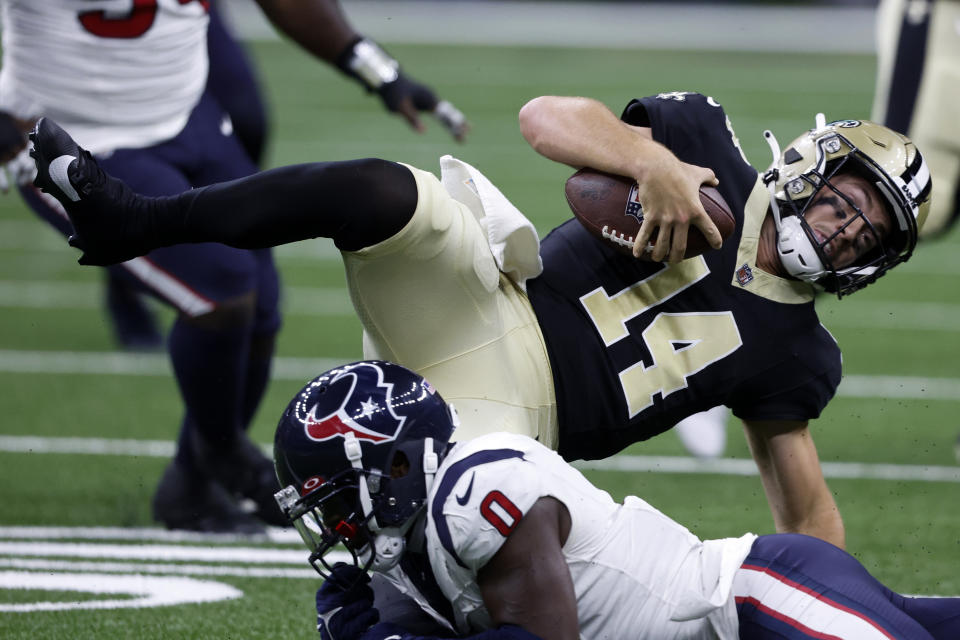 New Orleans Saints quarterback Jake Haener (14) is tackled by Houston Texans cornerback Desmond King II (0) in the first half of a preseason NFL football game, Sunday, Aug. 27, 2023, in New Orleans. (AP Photo/Butch Dill)