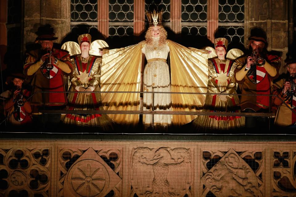 NUREMBERG, GERMANY - NOVEMBER 30: 17 year-old Franziska Handke (C) performs as 'Christkindles' (translates literally as 'Christ Child') during the opening ceremony of the traditional Christmas market 'Nuernberger Christkindlesmarkt' on November 30, 2012 in Nuremberg, Germany. Originating in the 16th century the Nuremberg Christmas market is seen as one of the oldest of its kind in Germany. (Photo by Johannes Simon/Getty Images)