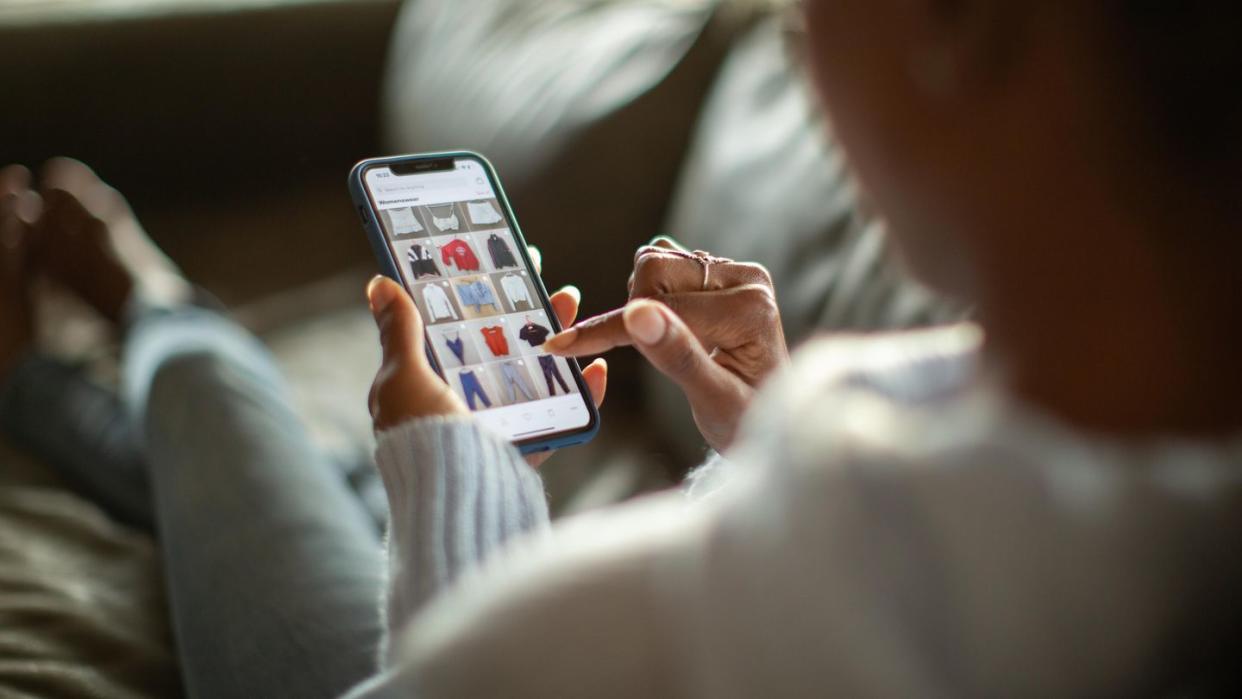 woman purchasing clothes on a mobile app