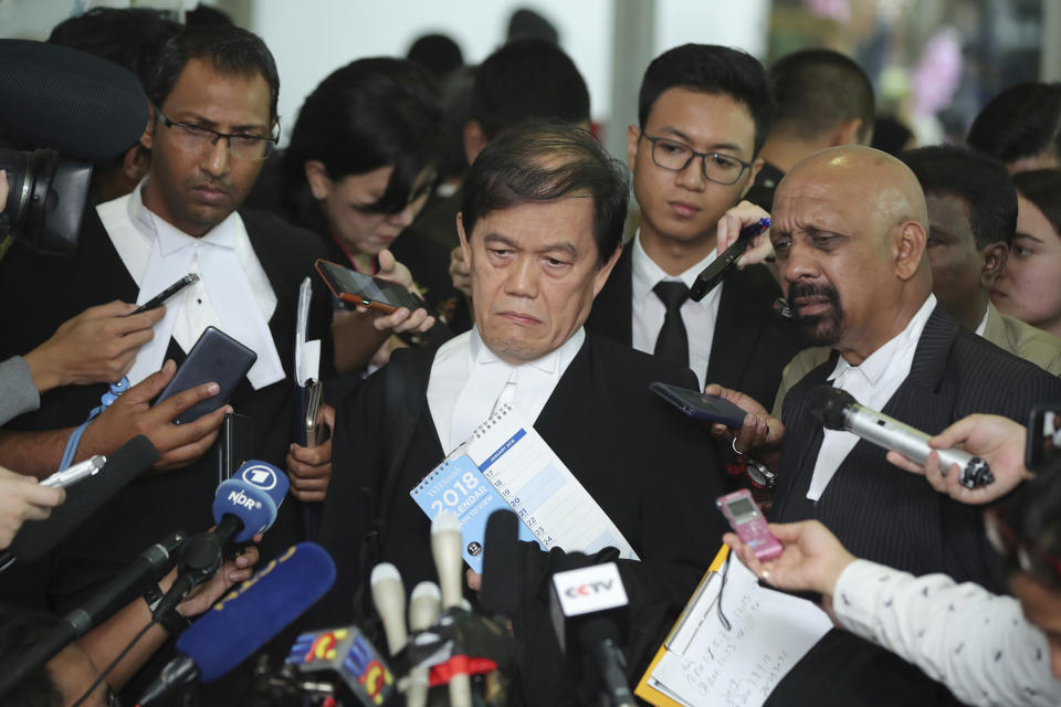 Hisyam Teh Poh Teik, center, and Naran Singh, right, lawyers for Vietnamese Doan Thi Huong speak during a press conference after court hearing at Shah Alam High Court in Shah Alam, Malaysia, Thursday, Aug. 16, 2018. Huong and Indonesia's Siti Aisyah, two Southeast Asian women on trial for the brazen assassination of the North Korean leader's half brother were told to begin their defense Thursday, extending the trial for several more months. (AP Photo/Jeffrey Ong)