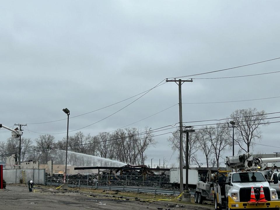 Clinton Township firefighters pour water onto the site of the former Goo Smoke Shop and Select Distributors on March 6, 2024, after a massive fire with explosions leveled the structure on March 5, 2024.
