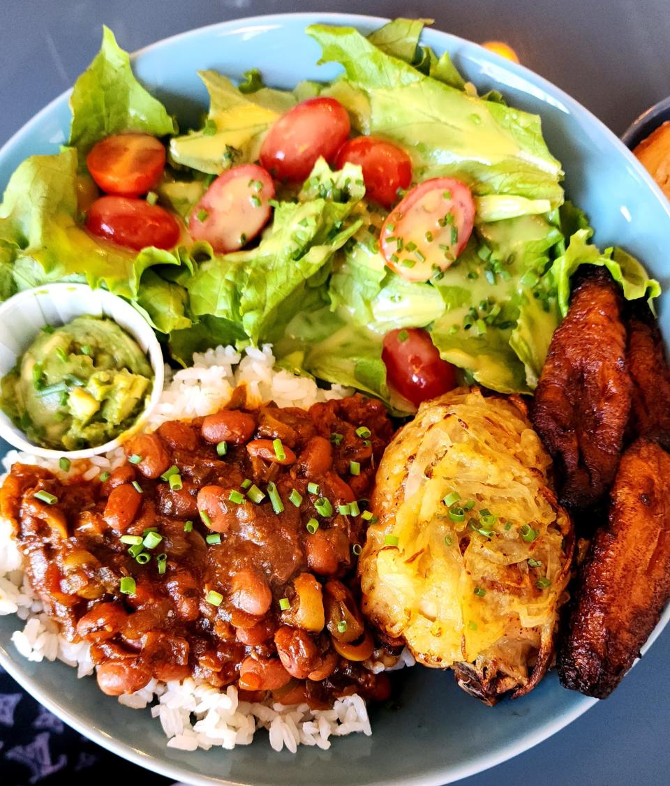 A beautifully curated chicken lunch special at Little Sister in Providence. The Puerto Rican dish includes plantains, beans and rice, avocado and salad.