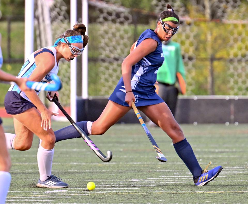Susannah Brown of Monomoy and Julia Gampietro of Sandwich run together for the ball.