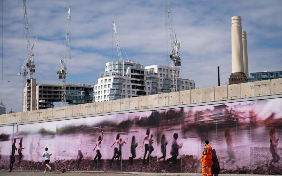 A view of tower blocks under construction and the redevelopment of Battersea Power station - PA