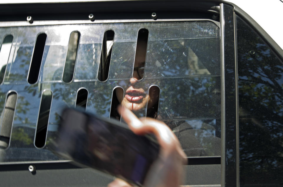 A pro Nicolas Maduro supporter Adrienne Pine is arrested, during the eviction of Maduro's supporters from the Venezuelan Embassy in Washington, Thursday, May 16, 2019. (AP Photo/Jose Luis Magana)