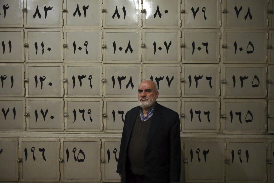 In this Monday, Jan. 7, 2019 photo, Ahmad Sheikhi, a 63-year-old former revolutionary, poses for a photo at a former prison run by the pre-revolution intelligence service, SAVAK, where he was once tortured, in Tehran, Iran. The former prison, now a museum, exhibits wax mannequins that silently portray the horrific acts of torture that once were carried out within its walls. As Iran marks the 40th anniversary of its Islamic Revolution and the overthrow of the shah, those who suffered torture at the hands of the police and dreaded SAVAK still bear the scars. (AP Photo/Ebrahim Noroozi)