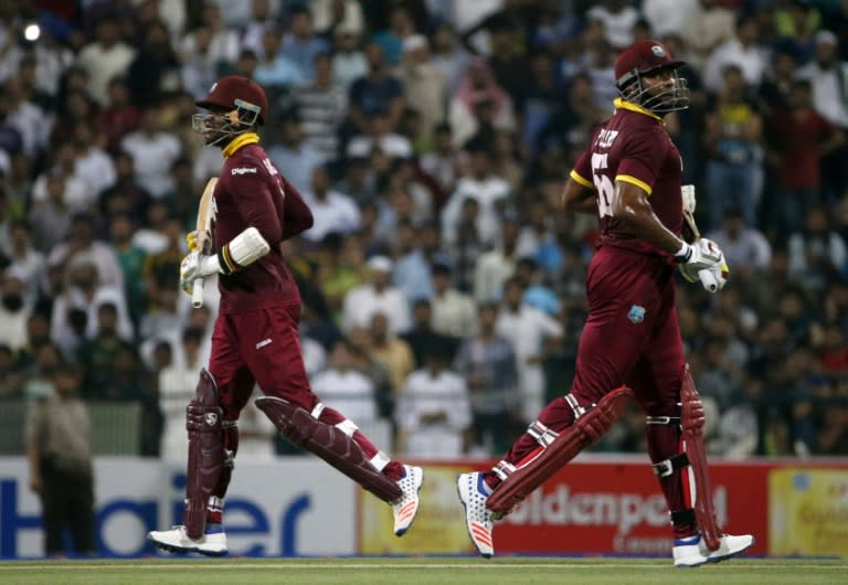 West Indies' Kieron Pollard (R) and Marlon Samuels (L) run between the wickets on September 27, 2016