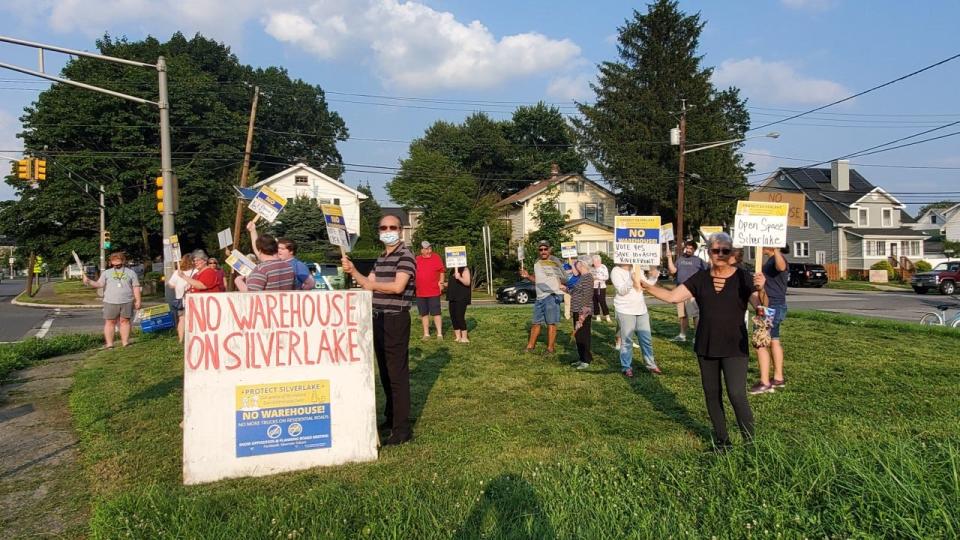 Edison residents rally against plans to build a large warehouse in a neighborhood off Silver Lake Avenue.