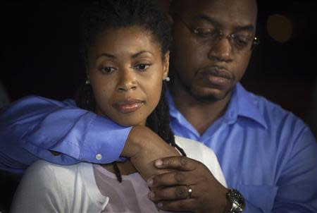 Amy Carey, sister of Miriam Carey, the woman involved in the Capitol Hill shooting, is seen with her husband at a news conference outside their home in the Brooklyn borough of New York, October 4, 2013. REUTERS/Carlo Allegri