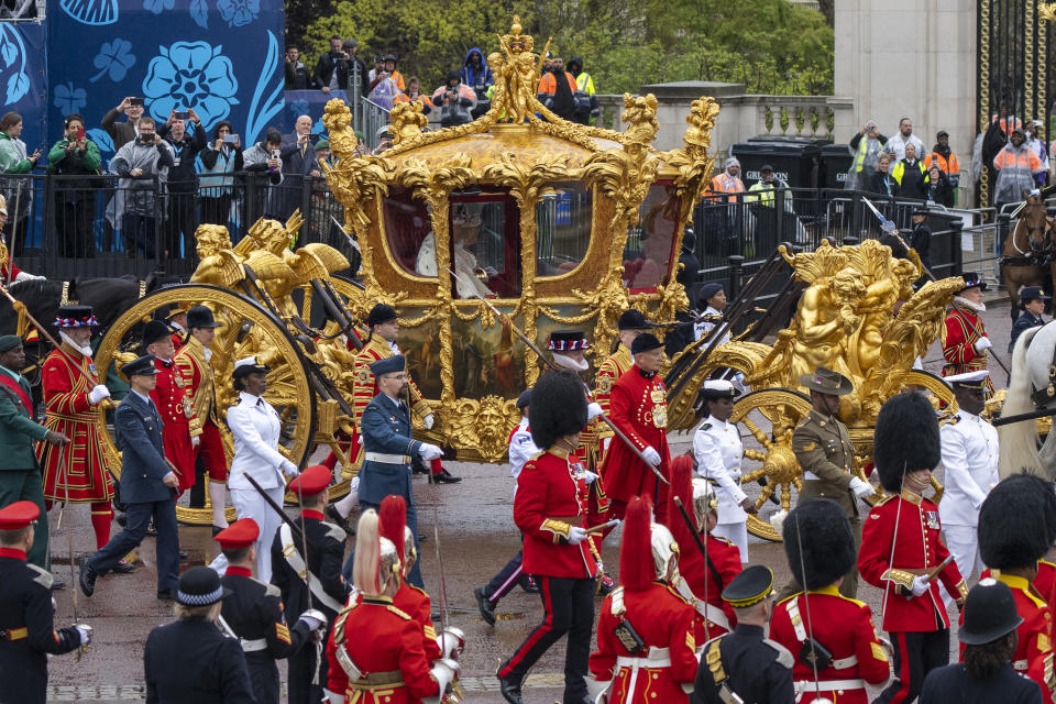 LONDON, ENGLAND - MAY 06: King Charles III and Queen Camilla travelling in the Gold State Coach, built in 1760 and used at every Coronation since that of William IV in 1831, setting off from Westminster Abbey on route to Buckingham Palace during the Coronation of King Charles III and Queen Camilla on May 06, 2023 in London, England. The Coronation of Charles III and his wife, Camilla, as King and Queen of the United Kingdom of Great Britain and Northern Ireland, and the other Commonwealth realms takes place at Westminster Abbey today. Charles acceded to the throne on 8 September 2022, upon the death of his mother, Elizabeth II.   (Photo by Christopher Furlong/Getty Images)