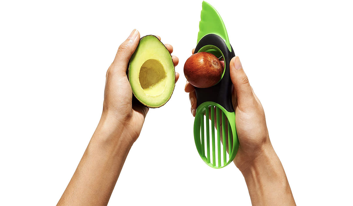 Person holding avocado tool