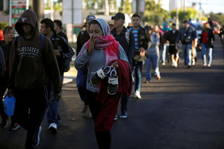 Salvadorans take part in a new caravan of migrants, set to head to the United States, as they leave San Salvador, El Salvador January 16, 2019. REUTERS/Jose Cabezas