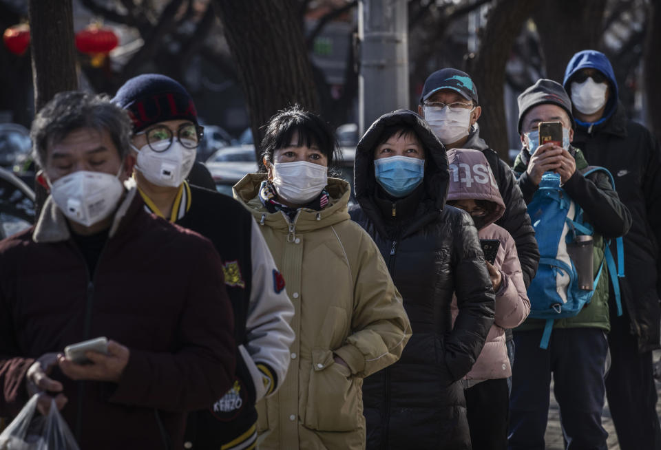 BEIJING, CHINA - FEBRUARY 16: Chinese customers wear protective masks as they line up single file to buy dumplings at a popular local shop on February 16, 2020 in Beijing, China. The number of cases of the deadly new coronavirus COVID-19 rose to more than 57000 in mainland China Sunday, in what the World Health Organization (WHO) has declared a global public health emergency. China continued to lock down the city of Wuhan in an effort to contain the spread of the pneumonia-like disease which medicals experts have confirmed can be passed from human to human. In an unprecedented move, Chinese authorities have maintained and in some cases tightened the travel restrictions on the city which is the epicentre of the virus and also in municipalities in other parts of the country affecting tens of millions of people. The number of those who have died from the virus in China climbed to over 1650 on Sunday, mostly in Hubei province, and cases have been reported in other countries including the United States, Canada, Australia, Japan, South Korea, India, the United Kingdom, Germany, France and several others. The World Health Organization has warned all governments to be on alert and screening has been stepped up at airports around the world. Some countries, including the United States, have put restrictions on Chinese travellers entering and advised their citizens against travel to China. (Photo by Kevin Frayer/Getty Images)
