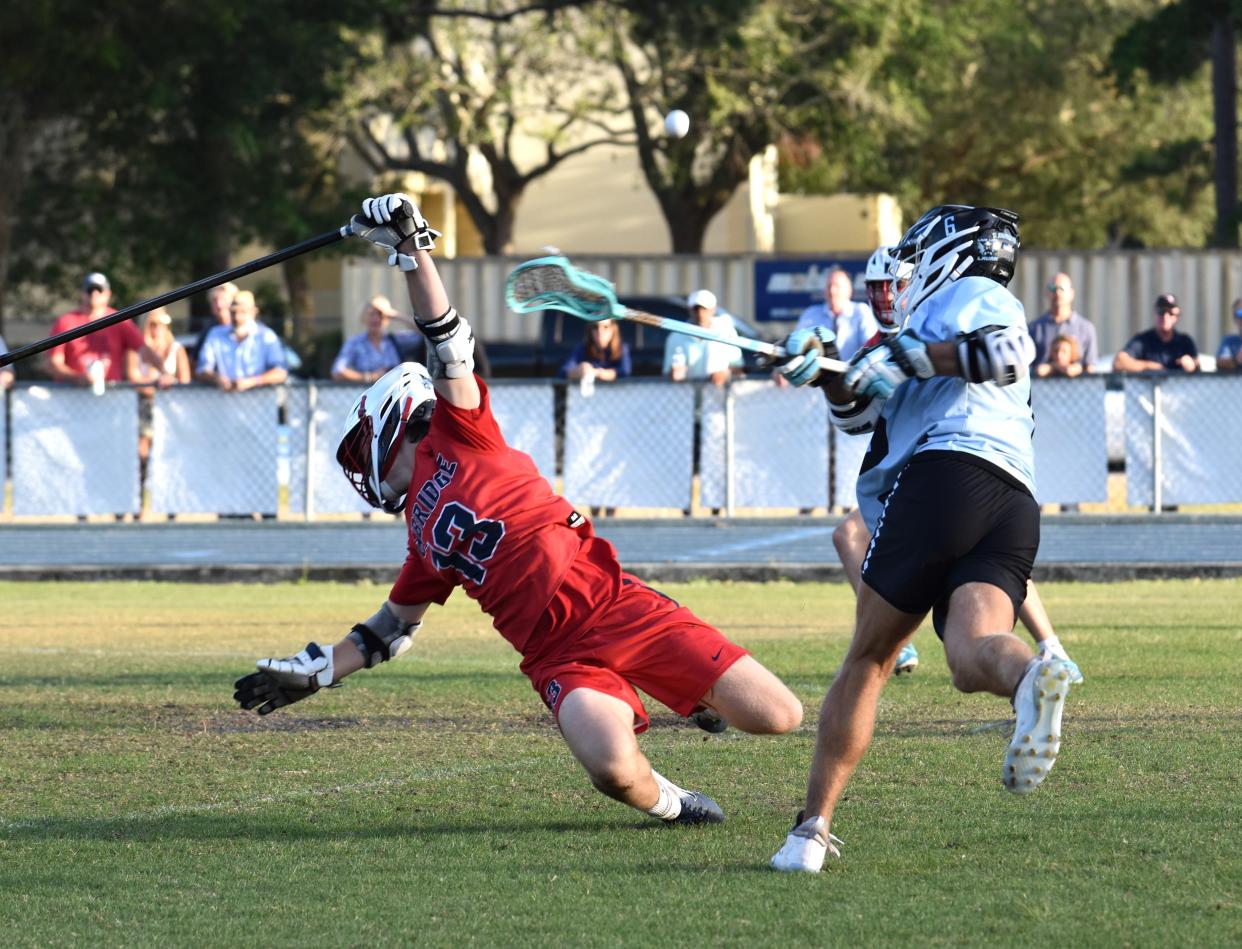 Oxbridge Academy's Remi DeOrsey dives trying to defend a shot during a district title game against St. John Paul II on April 16, 2024.