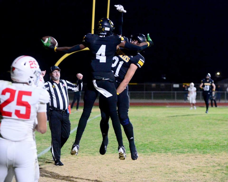 Hughson’s Malakai Sumter (4) and David Delgado (21) celebrate after Sumter caught a touchdown during a 2023 CIF Division 4-A Northern California Bowl game between Hughson and Palma at Hughson High School in Hughson, Calif. on Saturday, Dec. 2, 2023. Palma won the game 31-21.