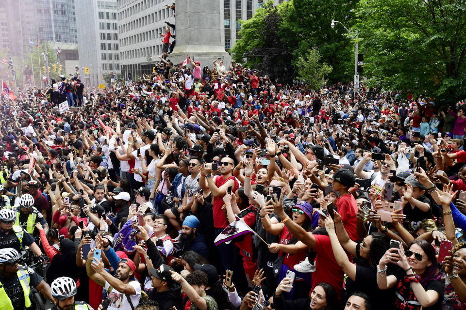 Toronto Raptors fans celebrate during the NBA basketball championship team's victory parade in Toronto, Monday, June 17, 2019. (Photo by Frank Gunn/The Canadian Press via AP)