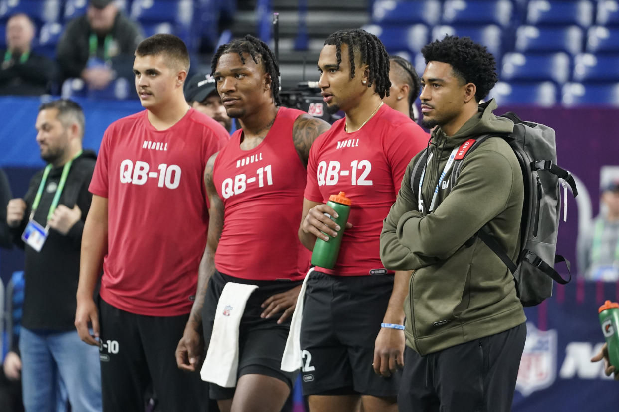 Alabama quarterback Bryce Young (far right) watches QB drills at the NFL combine with Purdue's Aidan O'Connell (far left), Florida's Anthony Richardson (second from left) and Ohio State QB CJ Stroud in Indianapolis, Saturday, March 4, 2023. (AP Photo/Darron Cummings)