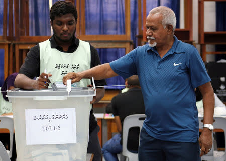 A man casts his vote at a polling station during the presidential election in Male, Maldives September 23, 2018. REUTERS/Ashwa Faheem