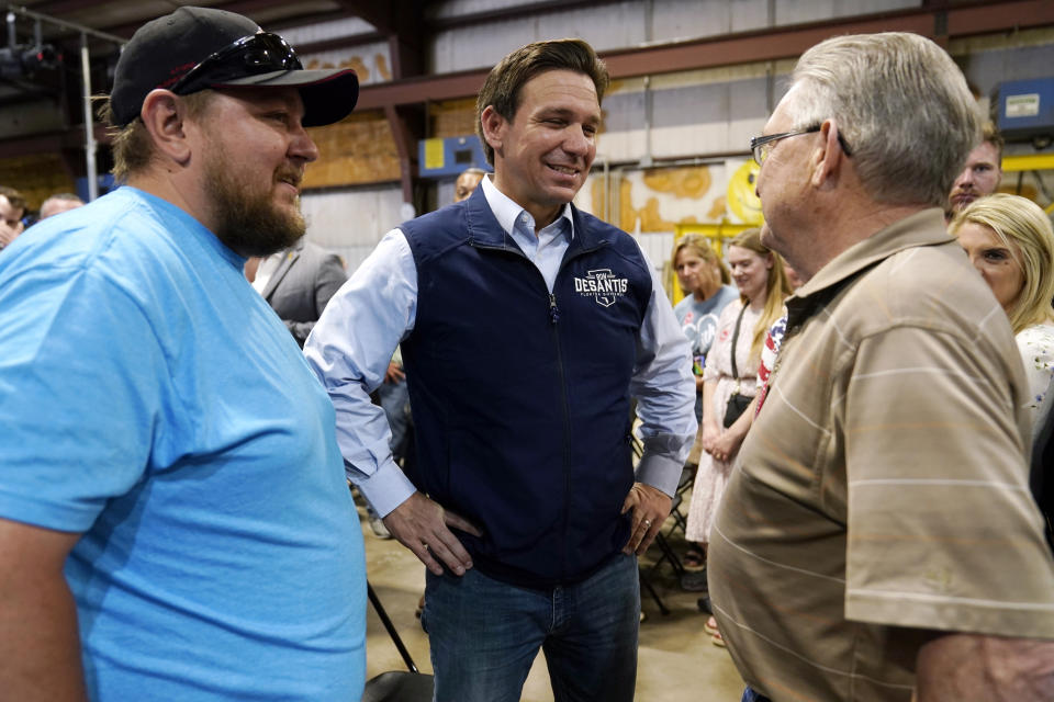 Republican presidential candidate Florida Gov. Ron DeSantis talks with an audience members during a campaign event at Port Neal Welding, Wednesday, May 31, 2023, in Salix, Iowa. (AP Photo/Charlie Neibergall)