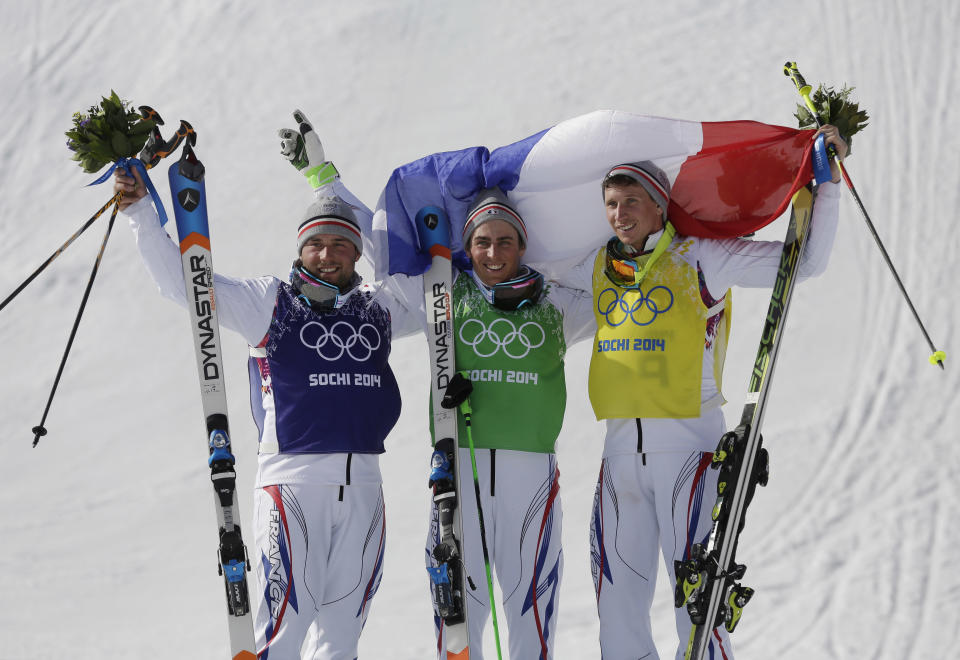 Men's ski cross gold medalist Jean Frederic Chapuis of France, center, celebrates with silver medalist Arnaud Bovolenta of France, left, and bronze medalist Jonathan Midol of France, at the Rosa Khutor Extreme Park, at the 2014 Winter Olympics, Thursday, Feb. 20, 2014, in Krasnaya Polyana, Russia. (AP Photo/Andy Wong)