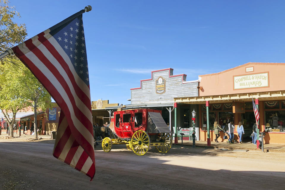 Tourists are seen visiting different stores in Tombstone, Ariz., on Saturday, Nov. 30, 2019. Tombstone is famous for a gun battle in 1881 that left three dead, a confrontation that has been the inspiration for numerous books and movies. While reenactments of the shootout are a popular tourist draw, the town has been working to offer a wide range of attractions that allow visitors to see what life was like in the Old West. (AP Photo/Peter Prengaman)
