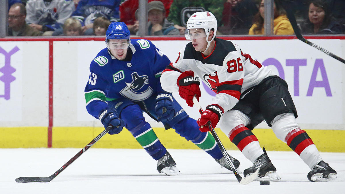 Hughes Bests Older Brother as Devils Rout Canucks 7-2 - Bloomberg