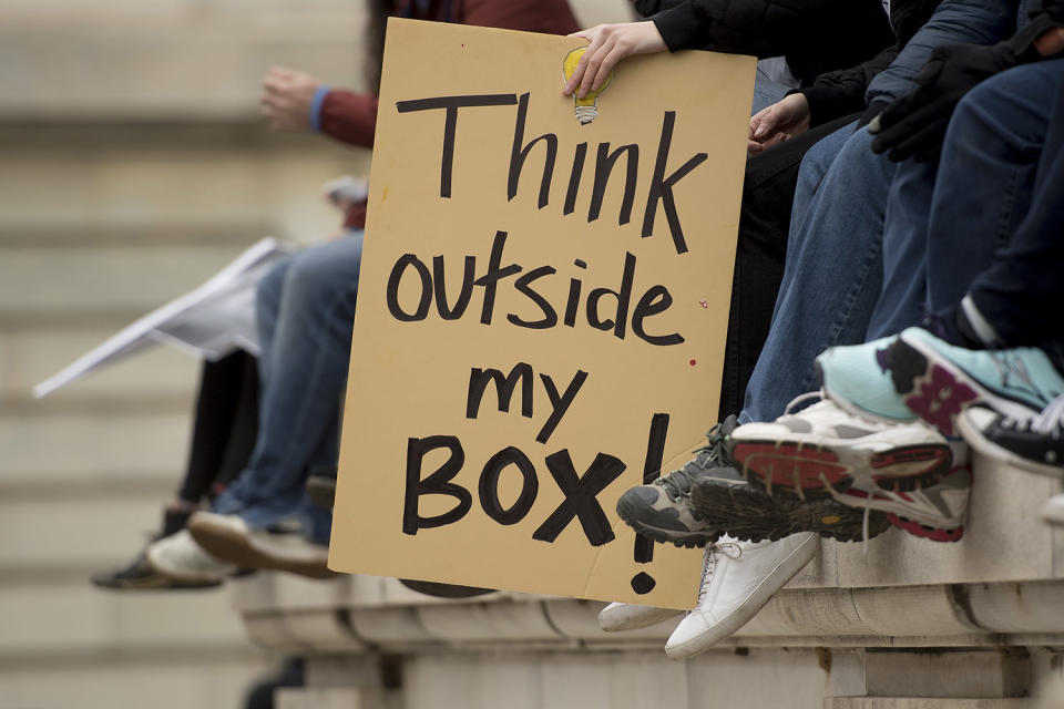 <p>Demonstrators sit on a wall on Independence Avenue during the Women’s March on Washington in Washington, DC, January 21, 2017. (JIM WATSON/AFP/Getty Images) </p>