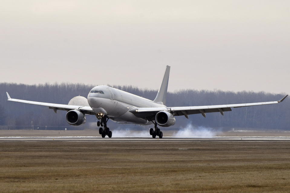 A Hungarian Airbus 330 plane transporting the first batch of the vaccine against the new coronavirus produced by Sinopharm of China to Hungary lands at Budapest Liszt Ferenc International Airport in Budapest, Hungary, Tuesday, Feb. 16, 2021. The vaccine will not be used without its examination and approval by the National Public Health Center. (Zoltan Mathe/MTI via AP)