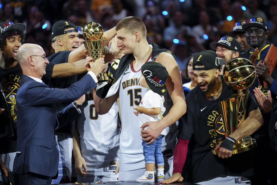 NBA commissioner Adam Silver, left, hands the MVP award to Denver Nuggets center Nikola Jokic, center, after the team won the NBA championship with a victory over the Miami Heat in Game 5 of the NBA Finals, Monday, June 12, 2023, in Denver. | Jack Dempsey, Associated Press