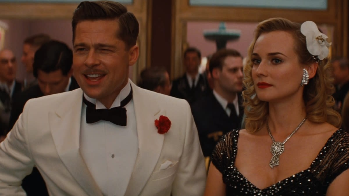  Brad Pitt, dressed in a white tuxedo next to Diane Kruger, in Inglourious Basterds. 