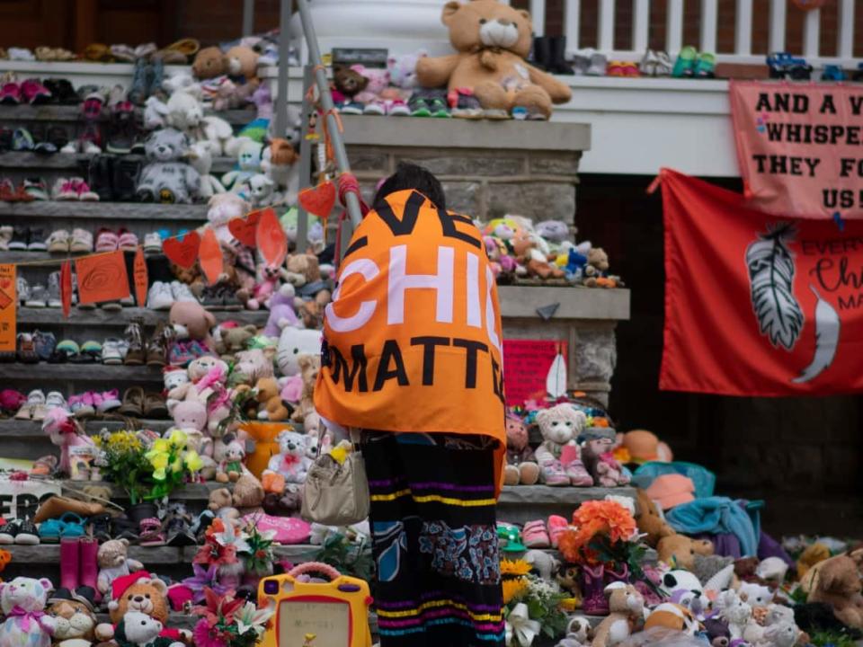 Shoes and stuffed toys cover the steps of the former Mohawk Institute Residential School in Brantford, Ont., on the National Day for Truth and Reconciliation. A new online resource with information for survivors, a project of the University of British Columbia, will be available starting Tuesday. (Bobby Hristova/CBC - image credit)