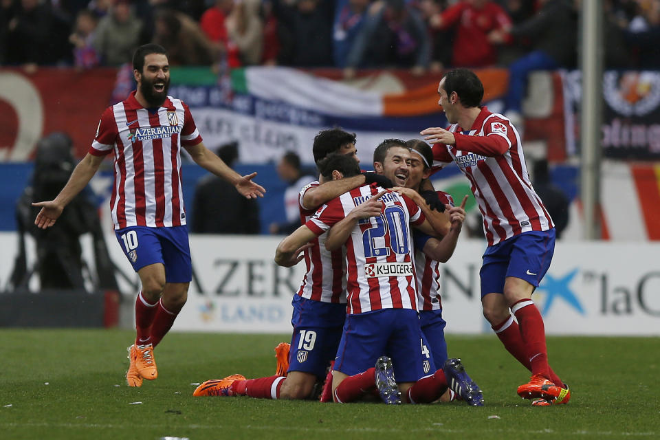 Atletico's Gabi, centre, facing camera, celebrates his goal during a Spanish La Liga soccer match between Atletico de Madrid and Real Madrid at the Vicente Calderon stadium in Madrid, Spain, Sunday, March 2, 2014. (AP Photo/Andres Kudacki)