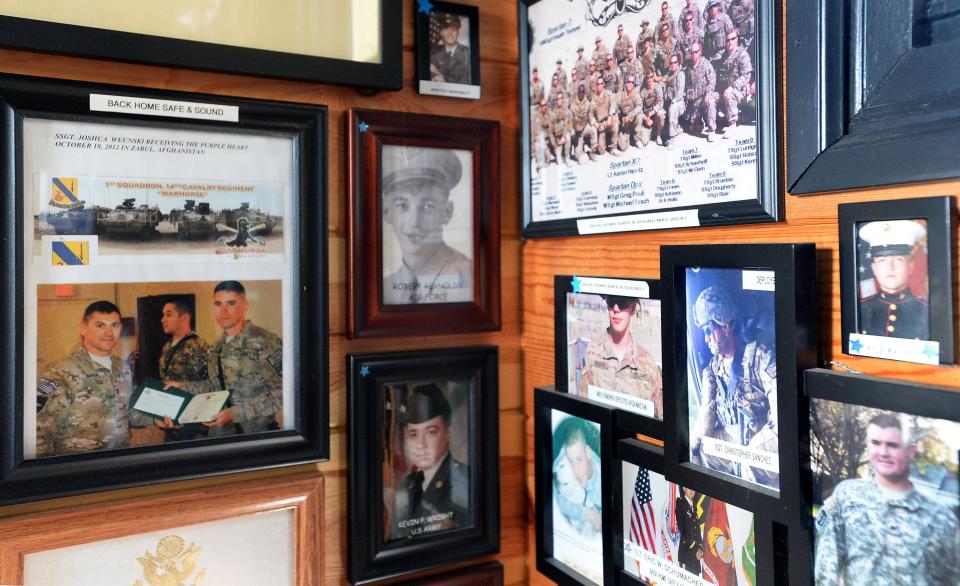 Pittsburgh Inn co-owner Robin Weunski keeps a "Wall of Honor" displaying pictures of hundreds of soldiers inside the restaurant, which is for sale.