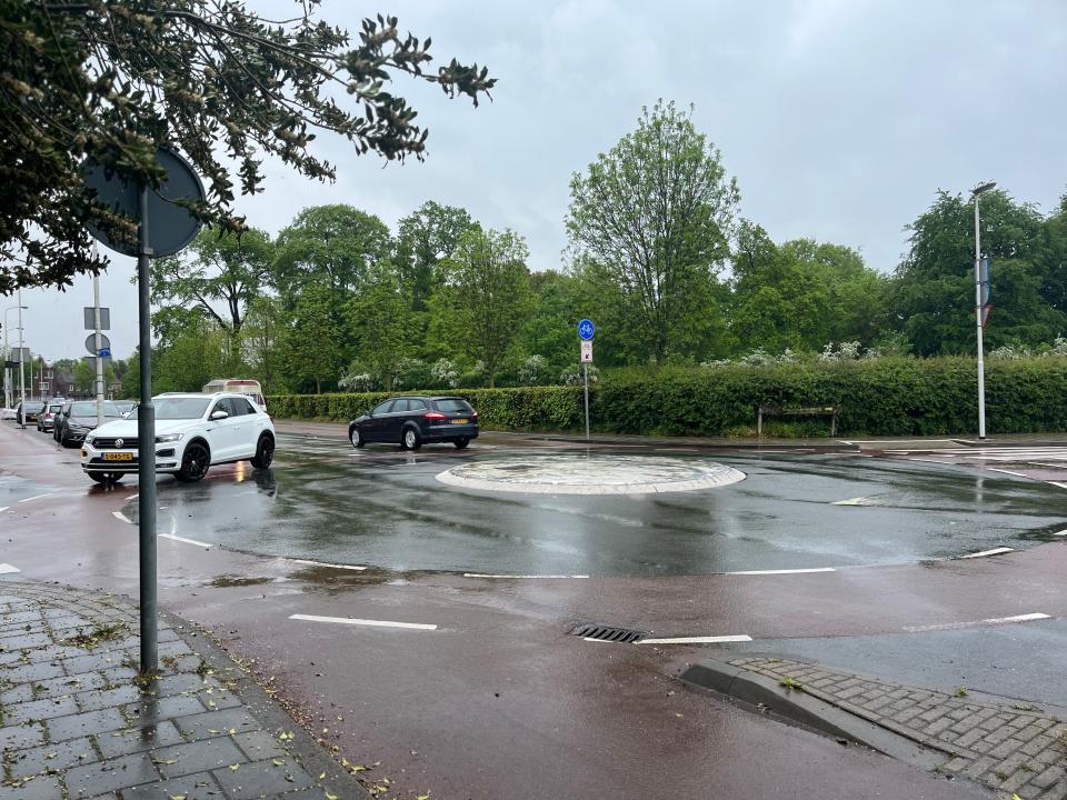 roundabout in the rain with cars on it