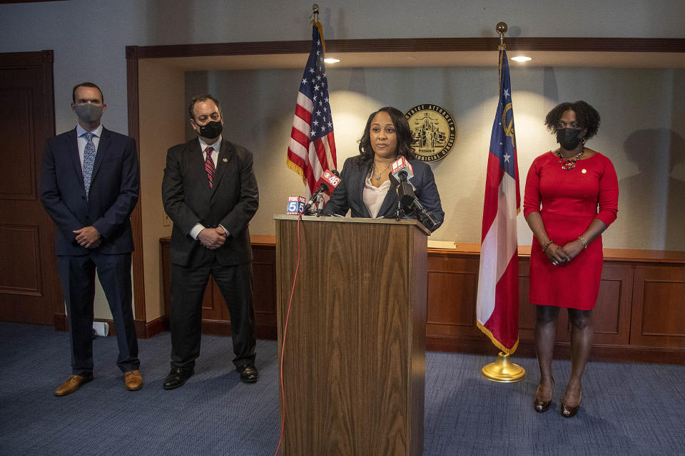 Fulton County District Attorney Fanni Willis, center, speaks during a news conference at the Fulton County Courthouse in downtown Atlanta, Friday, Aug. 13, 2021. A Fulton County grand jury has indicted two men, Julian Conley and Jerrion McKinney, in the involvement of the murder of 8-year-old Secoriea Turner. (Alyssa Pointer/Atlanta Journal-Constitution via AP)