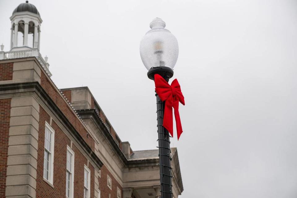 Christmas ribbons have been placed on light poles near the Historic Truman Courthouse. An Independence business owner said the ribbons belong to the production, but Independence would like to keep them.