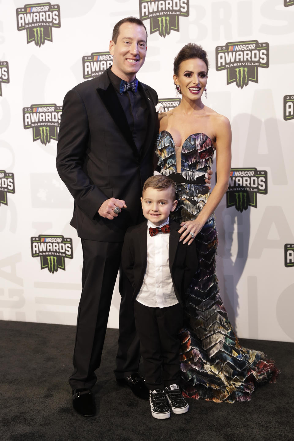 FILE -Driver Kyle Busch, his wife, Samantha, and son, Brexton, arrive for the NASCAR Cup Series Awards Thursday, Dec. 5, 2019, in Nashville, Tenn. Kyle Busch will move to Richard Childress Racing next season, ending a 15-year career with Joe Gibbs Racing because the team could not come to terms with NASCAR’s only active multiple Cup champion. Busch will drive the No. 8 Chevrolet for Childress in an announcement made Tuesday, Sept. 13, 2022, at the NASCAR Hall of Fame. (AP Photo/Mark Humphrey, File)