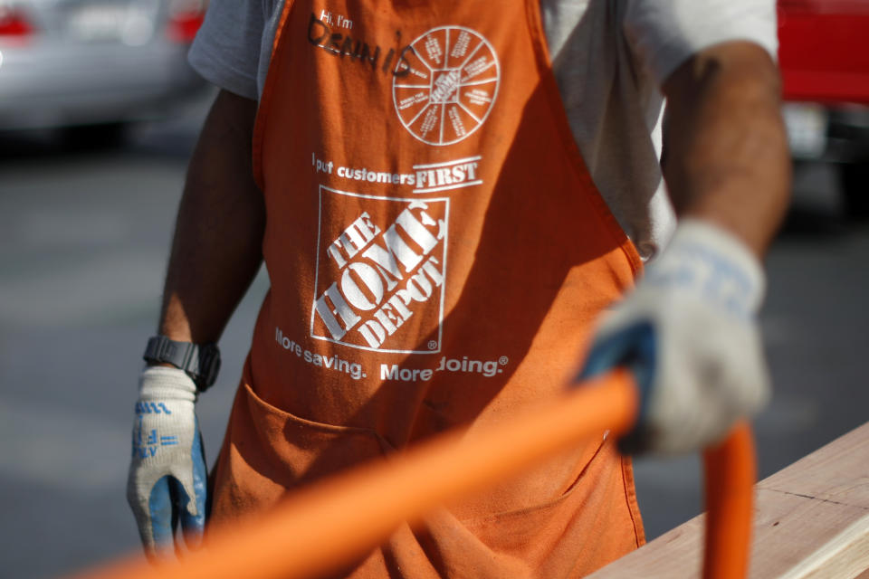 A Home Depot employee is seen outside a store in Los Angeles, California March 17, 2015. REUTERS/Lucy Nicholson (UNITED STATES - Tags: BUSINESS LOGO)