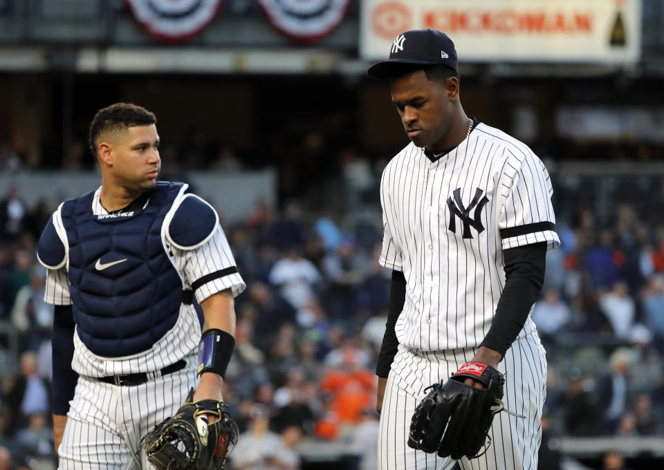 NEW YORK, NEW YORK - OCTOBER 15: Luis Severino #40 and Gary Sanchez #24 of the New York Yankees walk to the dugout prior to the fifth inning as the home plate umpire is replaced in game three of the American League Championship Series at Yankee Stadium on October 15, 2019 in New York City. (Photo by Elsa/Getty Images)
